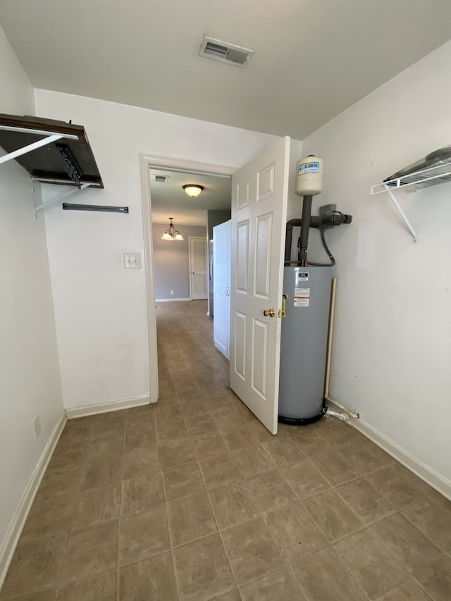 utility room featuring water heater