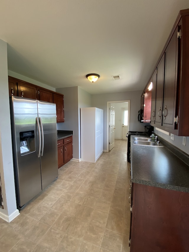 kitchen with sink and stainless steel fridge