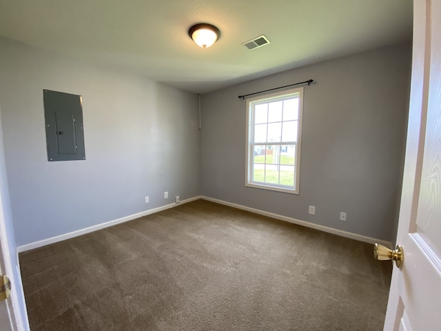 carpeted empty room featuring electric panel