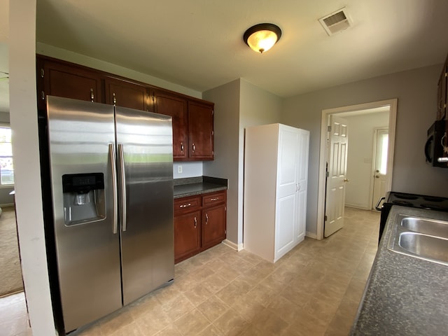 kitchen with stainless steel refrigerator with ice dispenser and sink