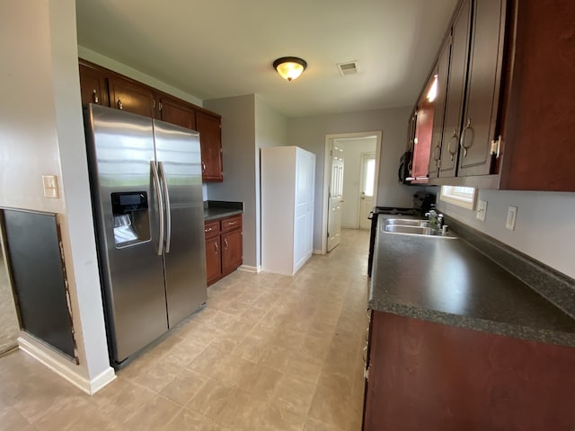 kitchen with stainless steel fridge with ice dispenser and sink