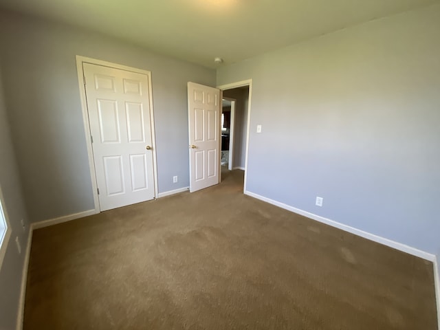 unfurnished bedroom with a closet and carpet flooring