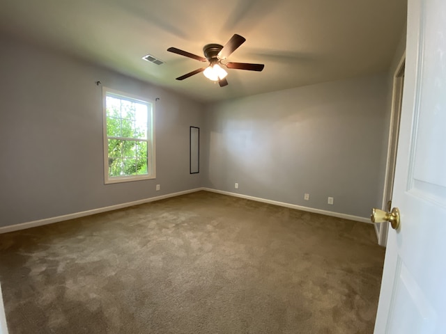 carpeted spare room with ceiling fan