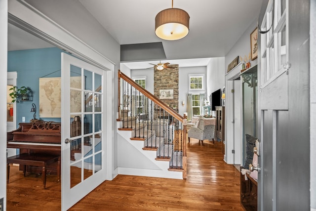 entrance foyer featuring ceiling fan, hardwood / wood-style flooring, and french doors