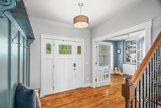 foyer entrance with light hardwood / wood-style flooring and plenty of natural light