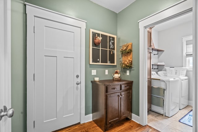 entrance foyer featuring light hardwood / wood-style flooring and independent washer and dryer