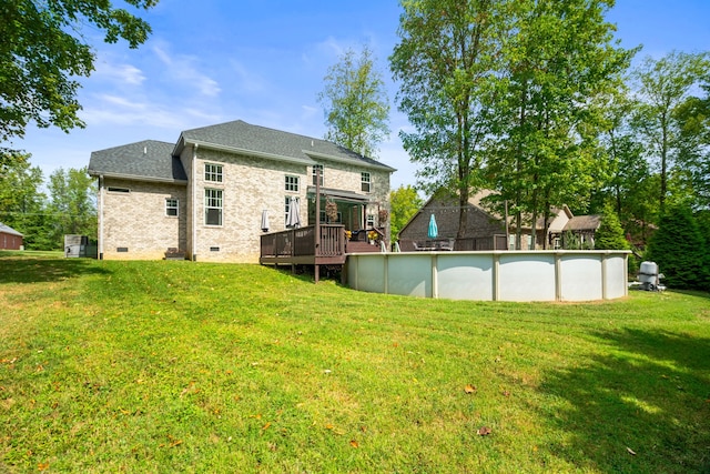 back of house with a lawn and a pool side deck