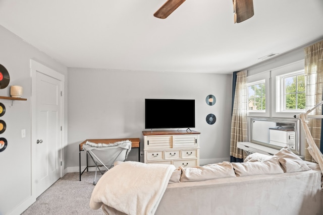 carpeted living room featuring ceiling fan