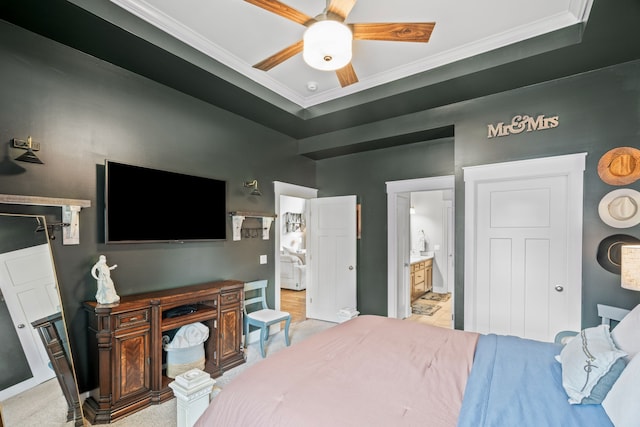 bedroom featuring ceiling fan, ensuite bath, ornamental molding, and light carpet