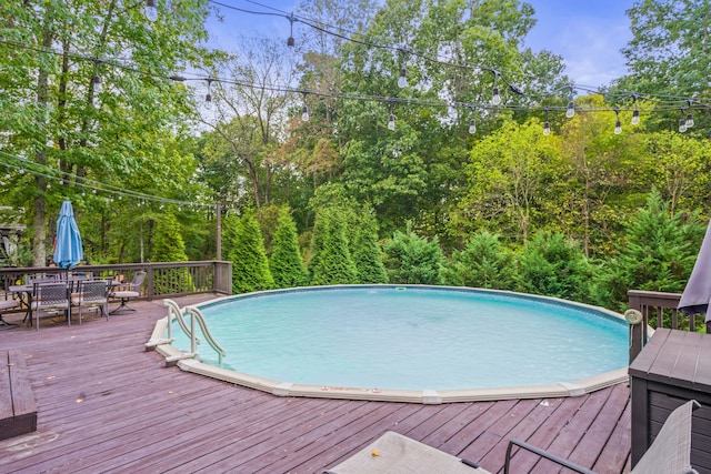 view of pool with a wooden deck