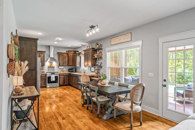 dining area featuring light wood-type flooring and sink