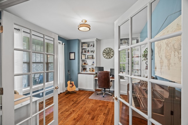 home office featuring french doors and hardwood / wood-style floors