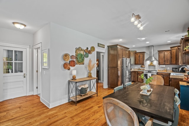 dining room with sink and light hardwood / wood-style flooring