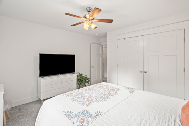 carpeted bedroom featuring a closet and ceiling fan