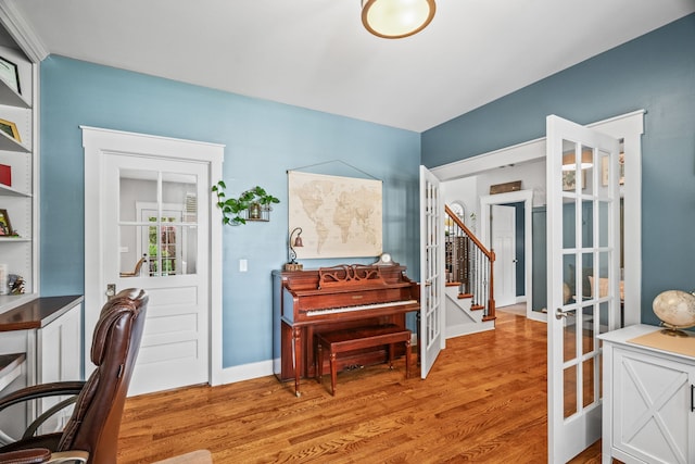 office area with light hardwood / wood-style floors and french doors