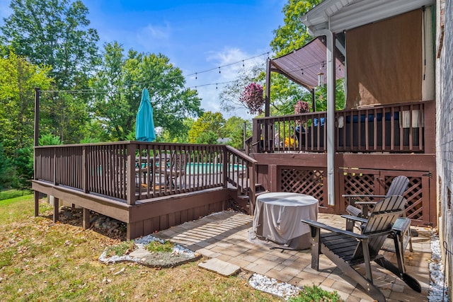 wooden terrace with a patio area