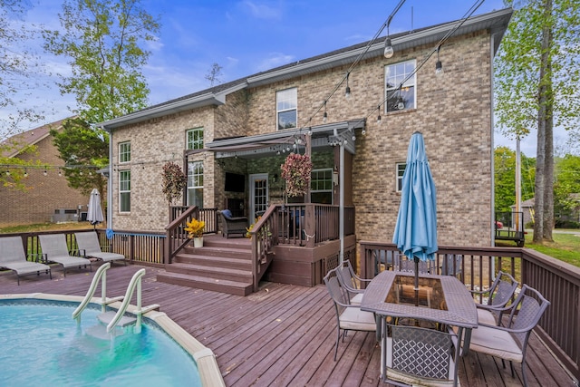 rear view of house featuring a pool side deck