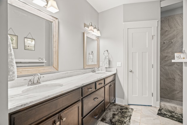 bathroom featuring vanity and tiled shower