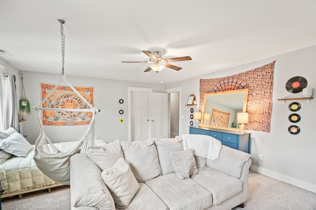 carpeted living room with ceiling fan