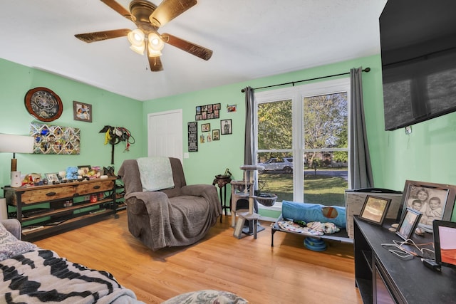 living room with ceiling fan and light hardwood / wood-style floors