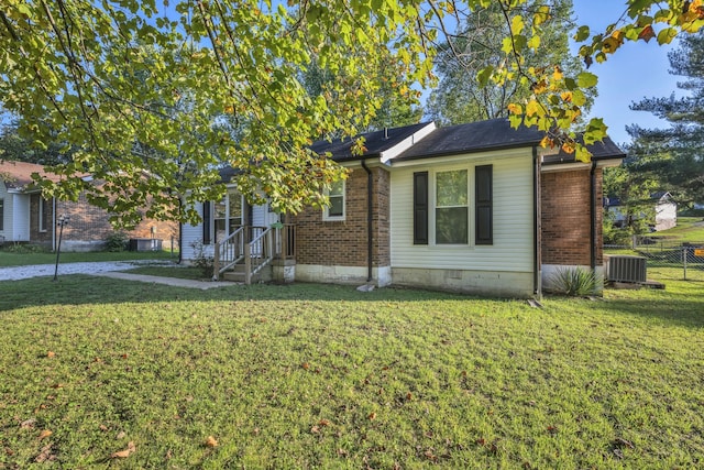 view of front of property featuring central air condition unit and a front yard