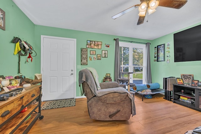 sitting room featuring ceiling fan and light hardwood / wood-style flooring