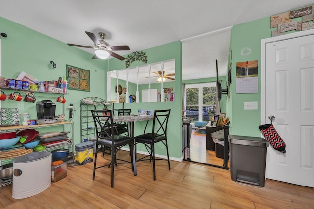 dining space featuring light wood-type flooring and ceiling fan