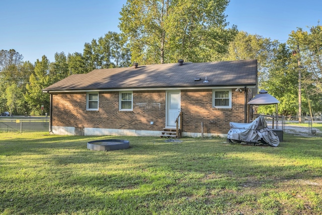 back of house with a lawn and a gazebo