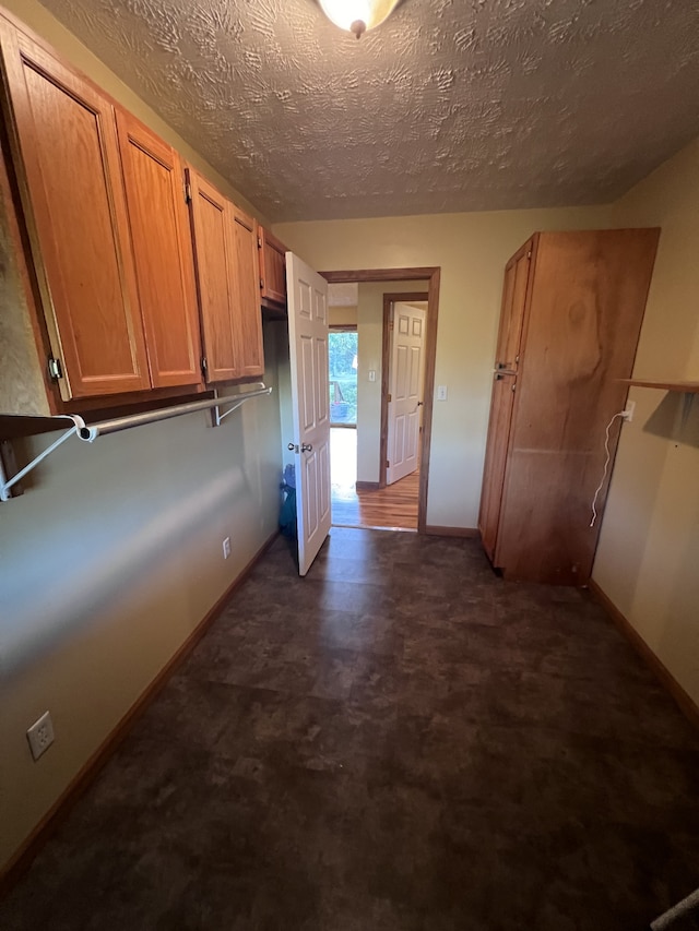 hallway with a textured ceiling