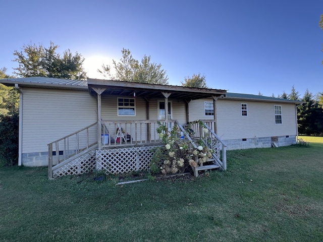 rear view of house with a yard