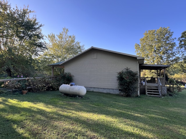 view of home's exterior featuring a lawn and a deck