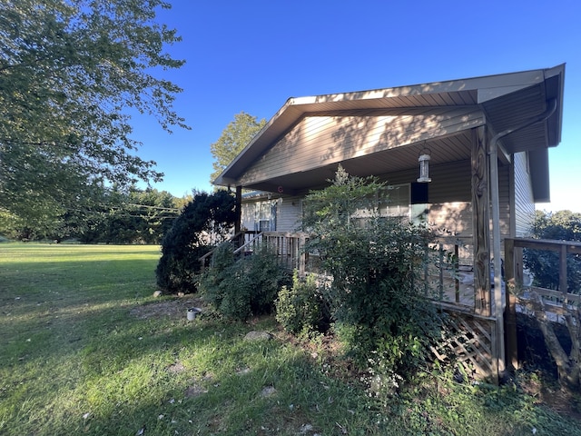 view of side of home with a lawn