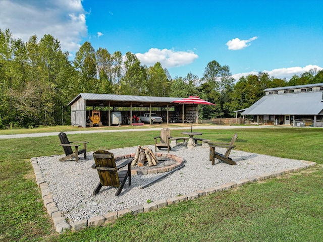 144 Abberly Ln, Hohenwald, TN 38462 - view of property's community with an outdoor fire pit, a yard, a pole building, and a detached carport