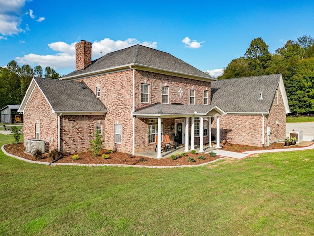144 Abberly Ln, Hohenwald, TN 38462 - view of side of home featuring a chimney, brick siding, roof with shingles, and a lawn