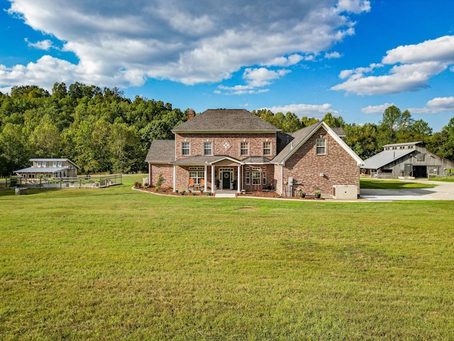 144 Abberly Ln, Hohenwald, TN 38462 - back of house featuring brick siding, a chimney, and a yard