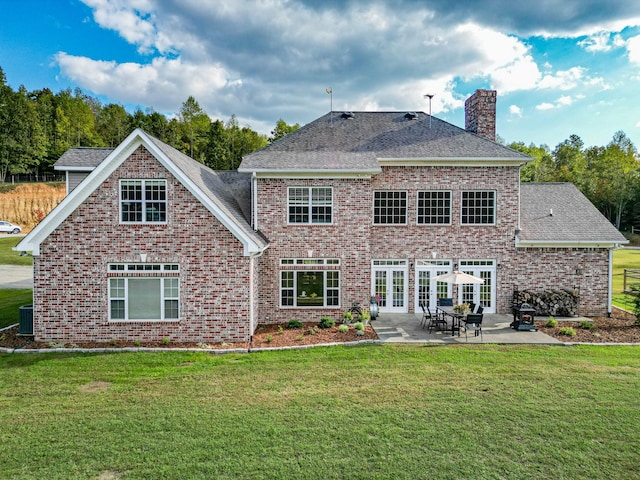 144 Abberly Ln, Hohenwald, TN 38462 - back of house with a chimney, a patio, a yard, brick siding, and roof with shingles