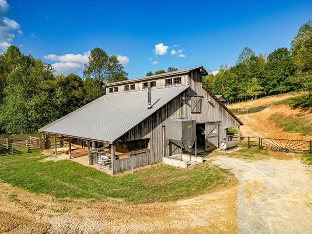 144 Abberly Ln, Hohenwald, TN 38462 - back of property with a barn, an outdoor structure, fence, and metal roof