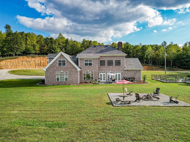 144 Abberly Ln, Hohenwald, TN 38462 - rear view of property with an outdoor fire pit, a patio area, and a lawn
