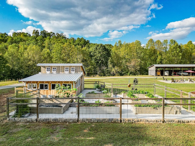 144 Abberly Ln, Hohenwald, TN 38462 - surrounding community featuring a garden, a wooded view, a pole building, and an outdoor structure