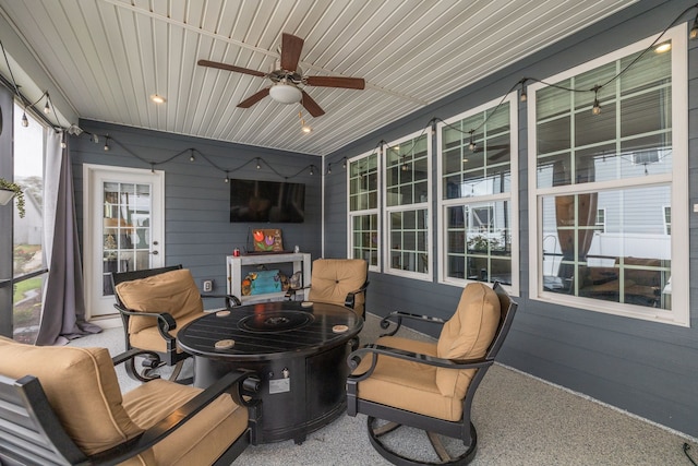 sunroom / solarium with wooden ceiling and ceiling fan