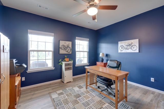 office space with light hardwood / wood-style floors and ceiling fan