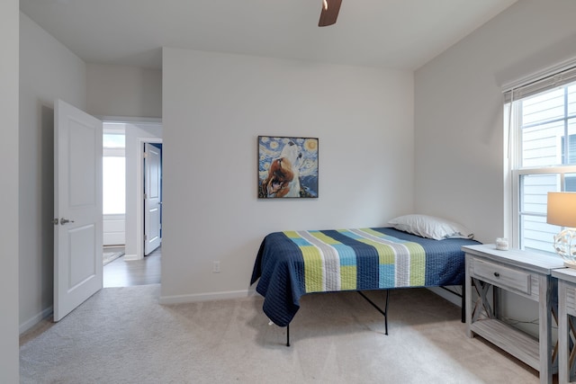 bedroom featuring ceiling fan and light colored carpet