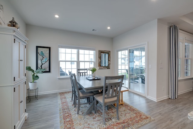 dining area featuring light hardwood / wood-style floors and a healthy amount of sunlight