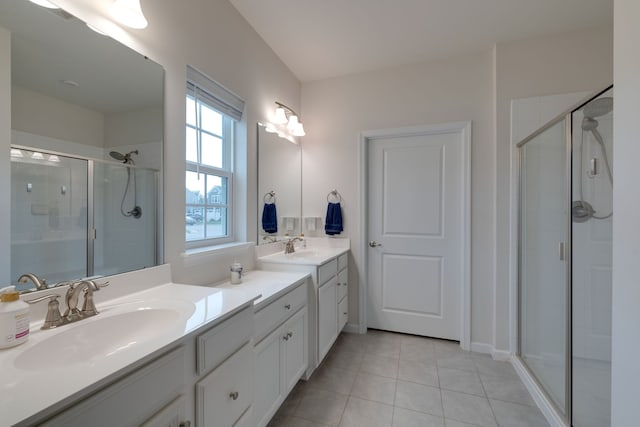 bathroom with tile patterned flooring, a shower with shower door, and vanity