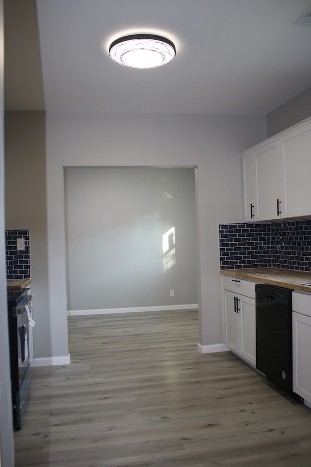 kitchen with light wood-type flooring, backsplash, white cabinetry, and black appliances