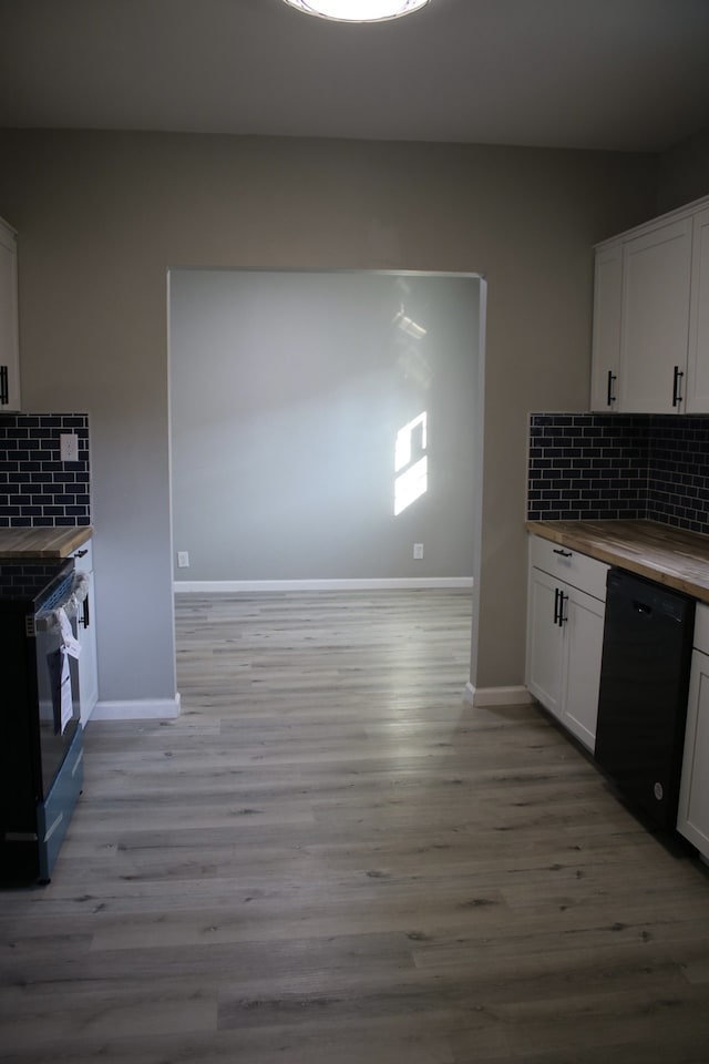 kitchen featuring white cabinets, backsplash, and black appliances