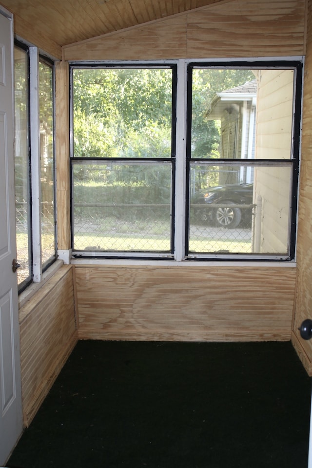 unfurnished sunroom featuring lofted ceiling and wooden ceiling