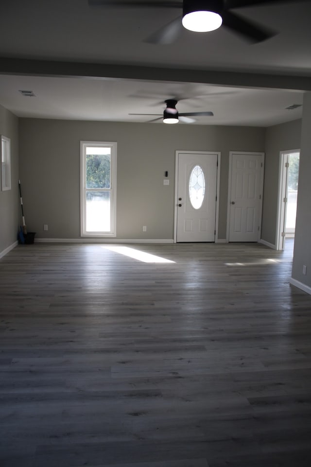 foyer entrance with beam ceiling and dark wood-type flooring