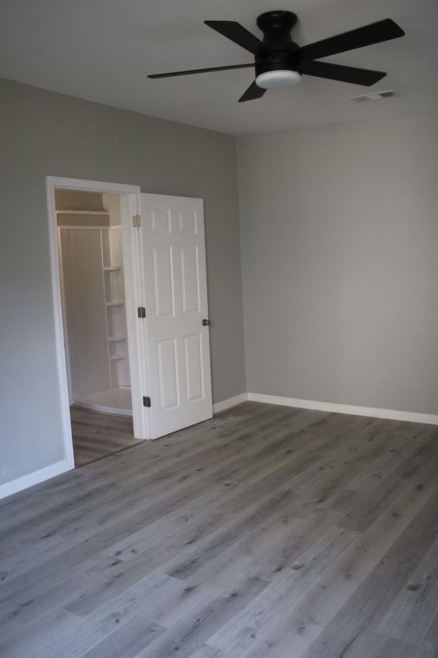 unfurnished room featuring ceiling fan and light wood-type flooring