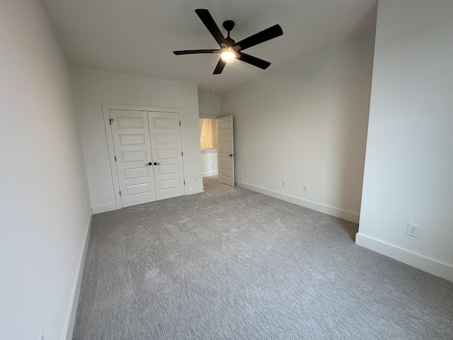 unfurnished bedroom with ceiling fan, a closet, and carpet